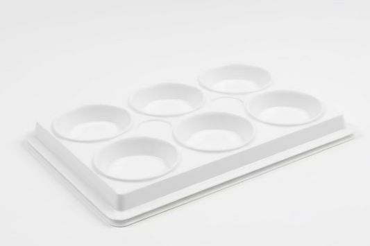 White plastic paint palette with six circular cavities