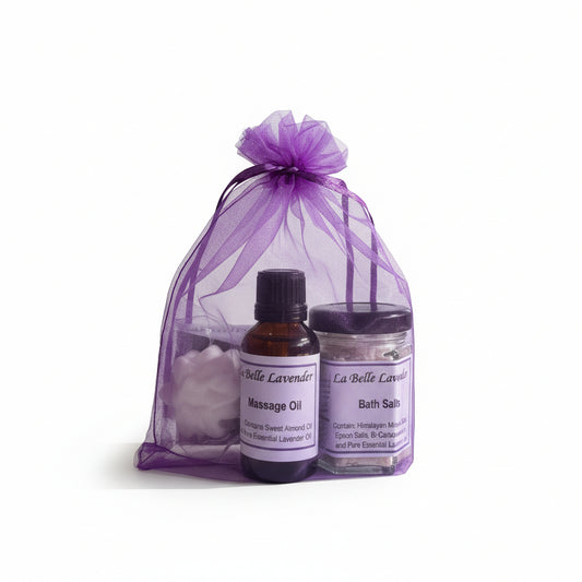 La Belle Lavender massage oil and bath salts set in a purple drawstring bag on a white background