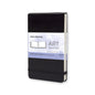 A Moleskine Art Collection watercolor album notebook, featuring a black textured cover, elastic closure, and a white and purple label on the front.