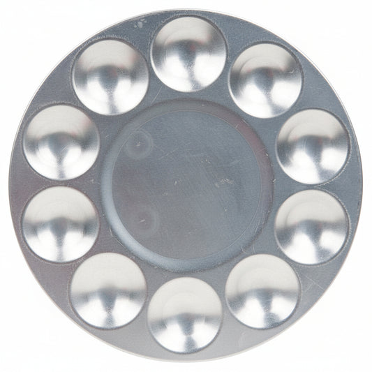 A round silver metal makeup palette with ten circular wells arranged in a ring around a central well, shown on a plain white background.