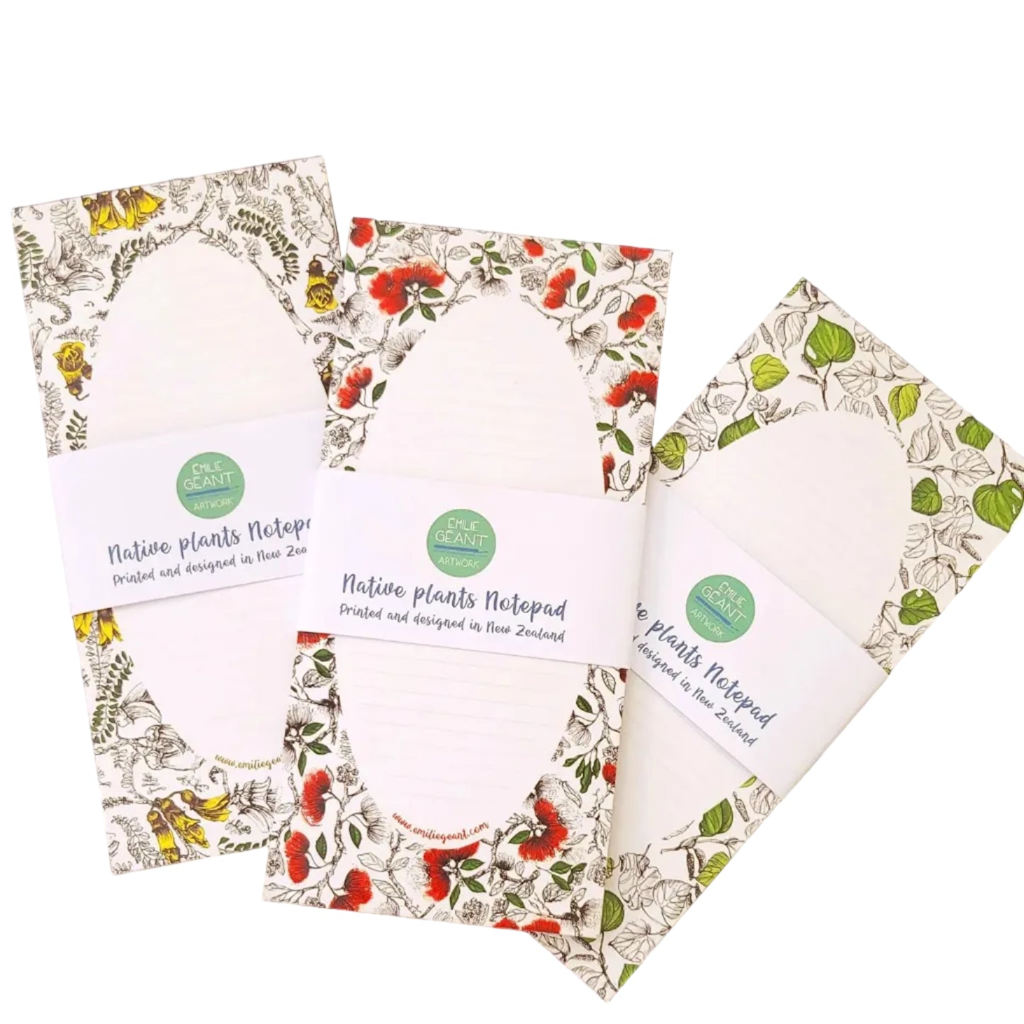 Three floral-patterned notebooks on a blue wooden surface